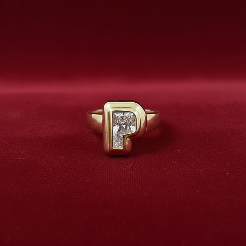 The Lucky Letter Signet: Bold, chunky pinky ring featuring a letter cut lab grown diamond with 2 sculptural bezels and a tapered band all cast in sterling silver or solid gold